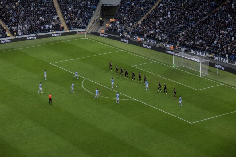 Defending team packed into a deep low block near their own penalty area during a Manchester City attack at the Etihad Stadium